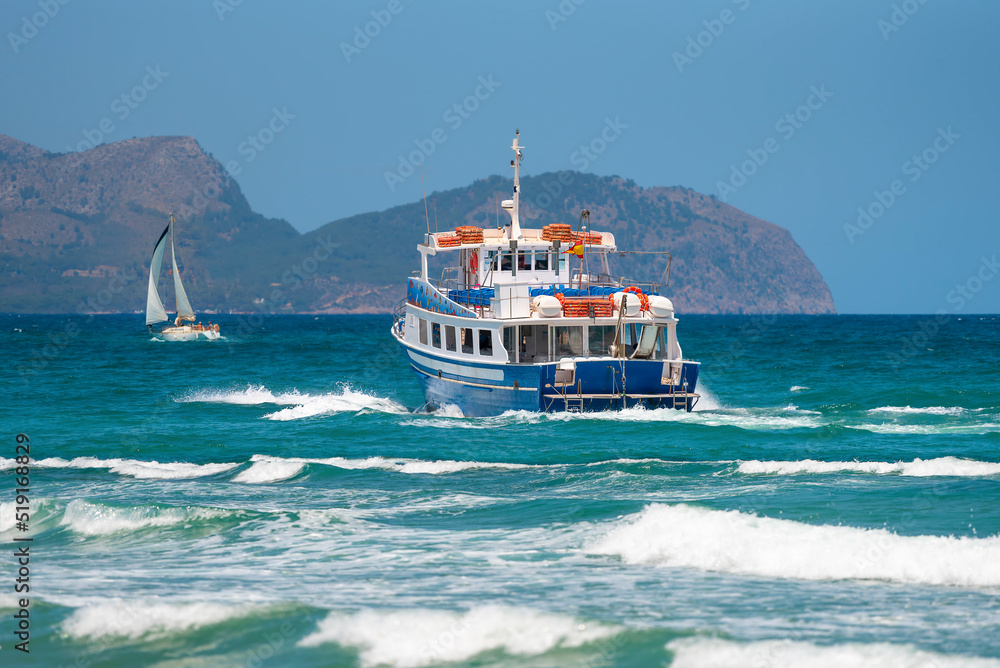 Pleasure tourist ship on the background of the sea and mountains