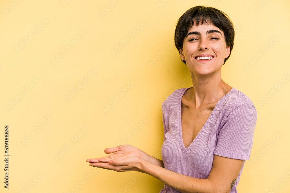 Young caucasian woman with a short hair cut isolated holding a copy space on a palm. Young caucasian woman with a short hair cut isolated holding a copy space on a palm.