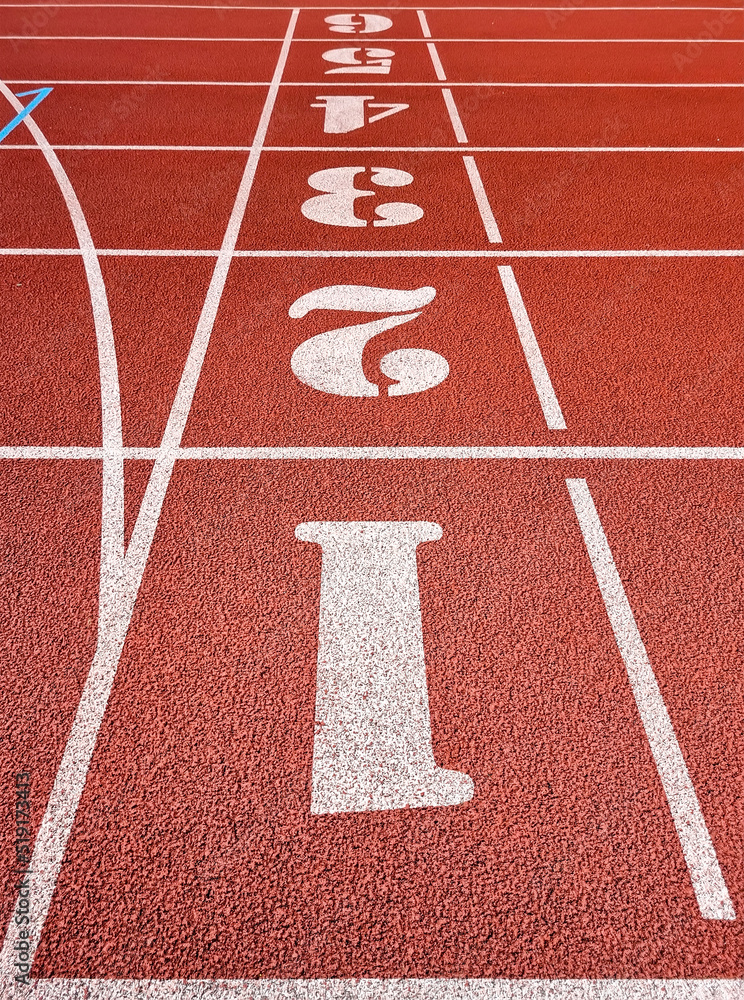 Red running tracks in the athletics stadium. Background image of empty tracks for running.