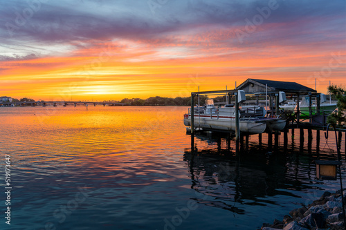 Sunset on the Lafayette River with boats on a dock and peaceful water © Kyle