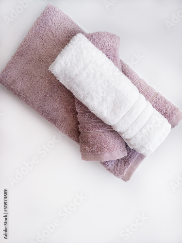 Twisted pink and white towels on the white background.