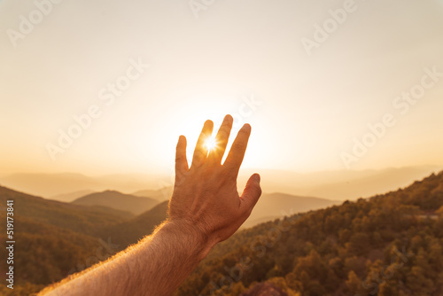 male hand reaching out in summer