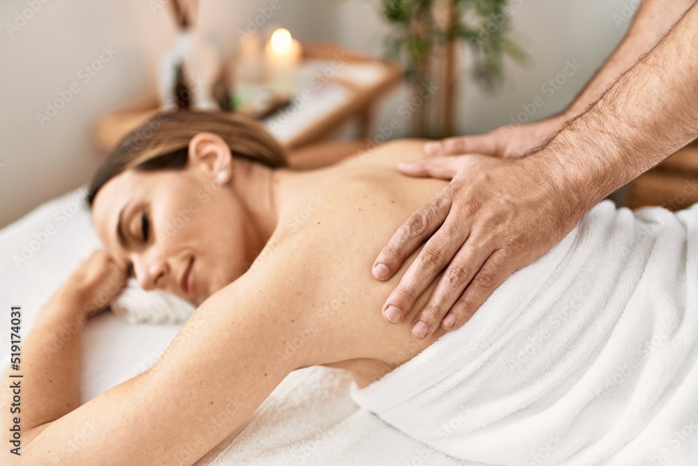 Woman smiling happy reciving back massage at beauty center. Woman smiling happy reciving back massage at beauty center.