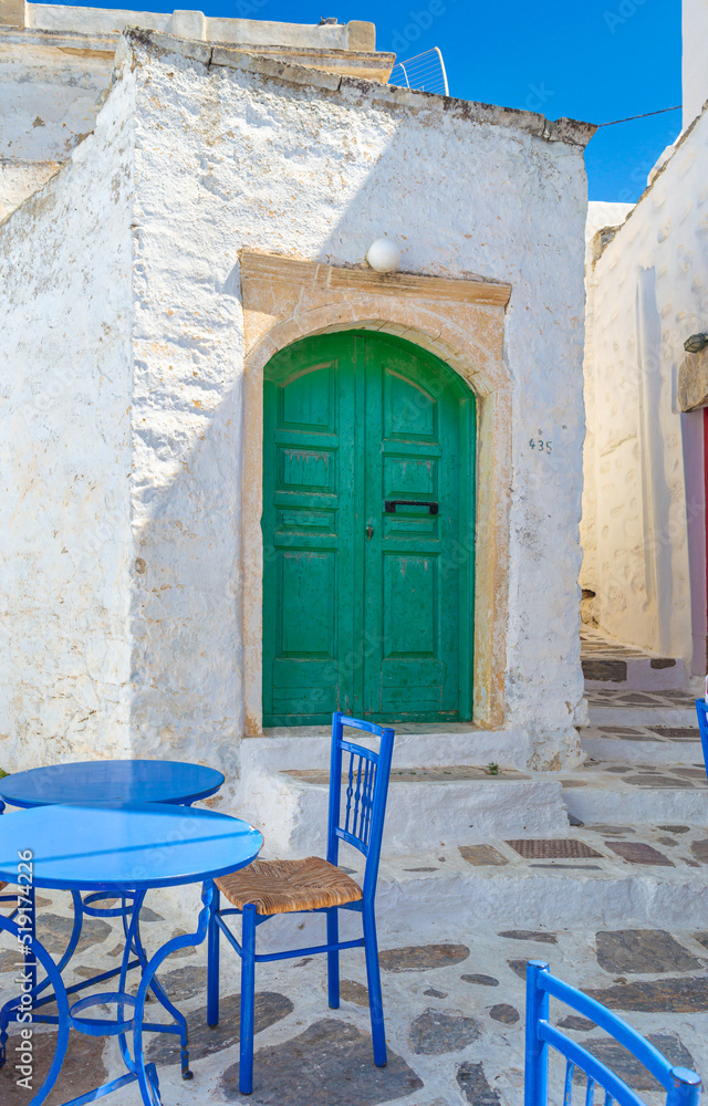 Fototapeta premium A wooden green colored door of a Beautiful traditional house in Chora the capital of Amorgos island in Greece
