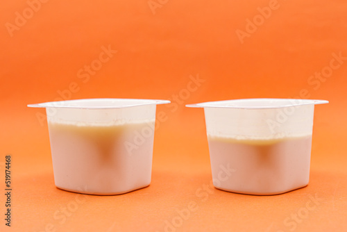 Fotografie Yogurt less full than the previous one. Shrinkflation concept