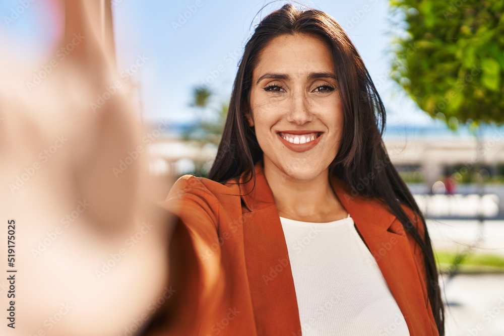 Young hispanic woman smiling confident making selfie by the camera at street Young hispanic woman smiling confident making selfie by the camera at street