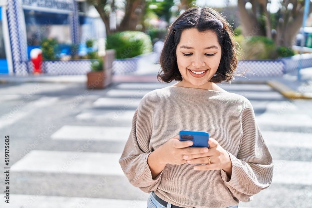 Young woman smiling confident using smartphone at street Young woman smiling confident using smartphone at street