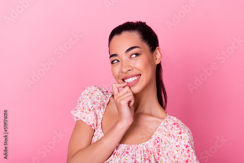 Portrait of lovely minded vietnamese girl bite finger nail look empty space fantasize isolated on pink color background