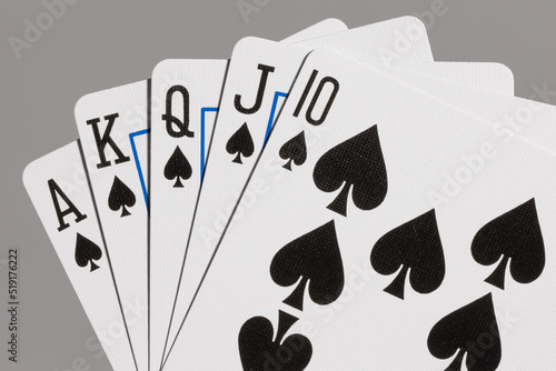 Close-up of poker hand showing royal flush in spades