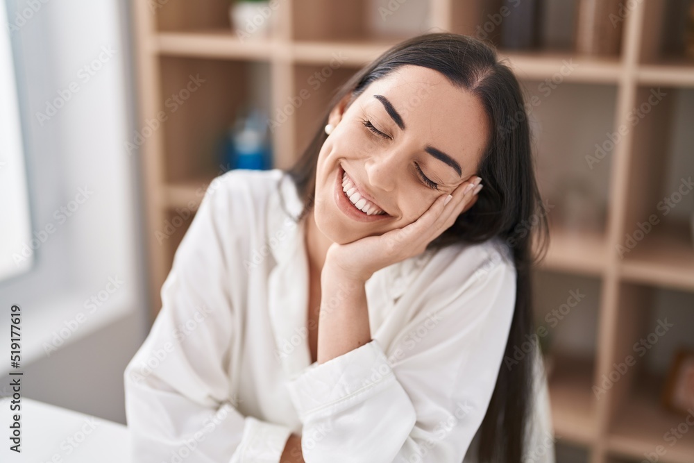 Young hispanic woman smiling confident sitting on table at home Young hispanic woman smiling confident sitting on table at home