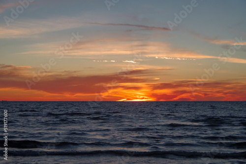 Colorful orange sunset over Baltic sea on clear summer day 