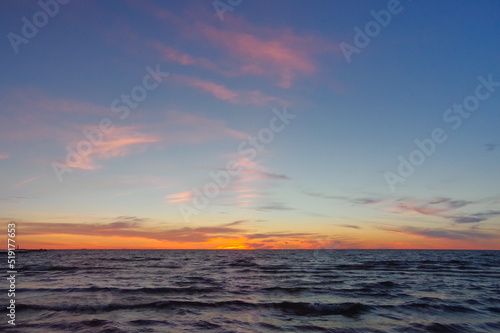 Colorful orange sunset over Baltic sea on clear summer evening