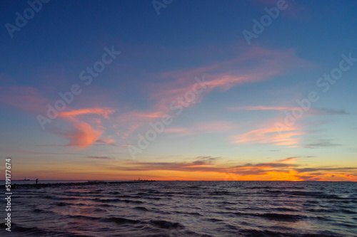 Colorful orange sunset over Baltic sea on clear summer day