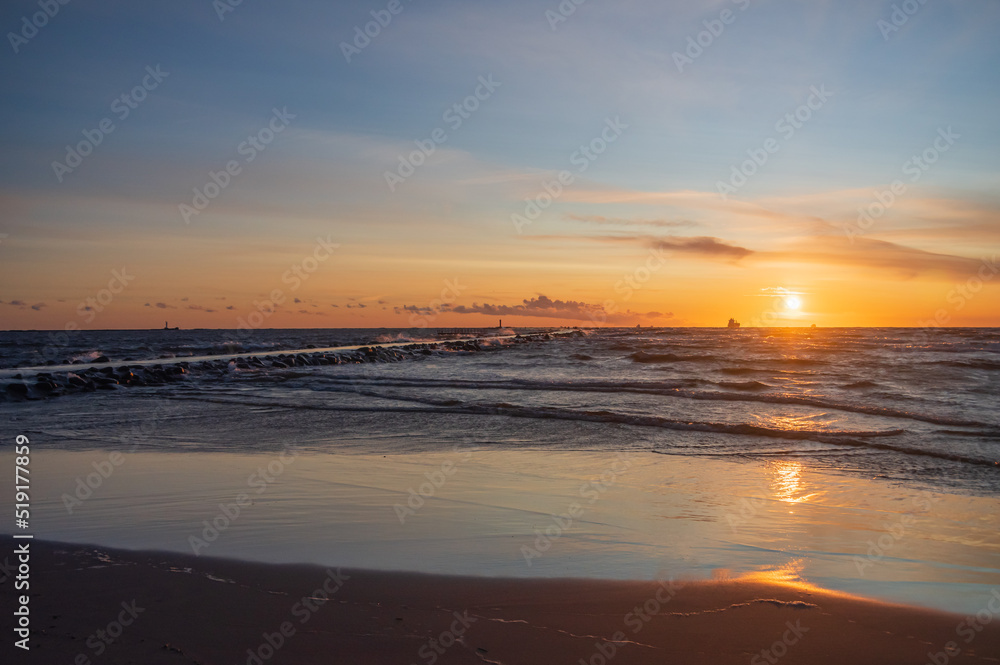 Colorful orange sunset over Baltic sea on clear summer evening