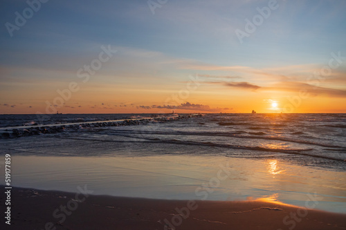 Colorful orange sunset over Baltic sea on clear summer evening