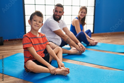 Family smiling confident stretching at sport center