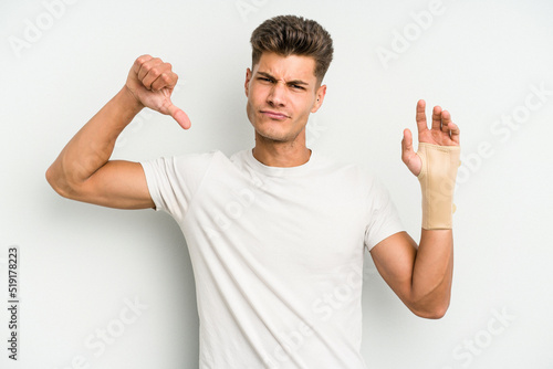 Young caucasian man hand sling isolated on white background feels proud and self confident, example to follow.