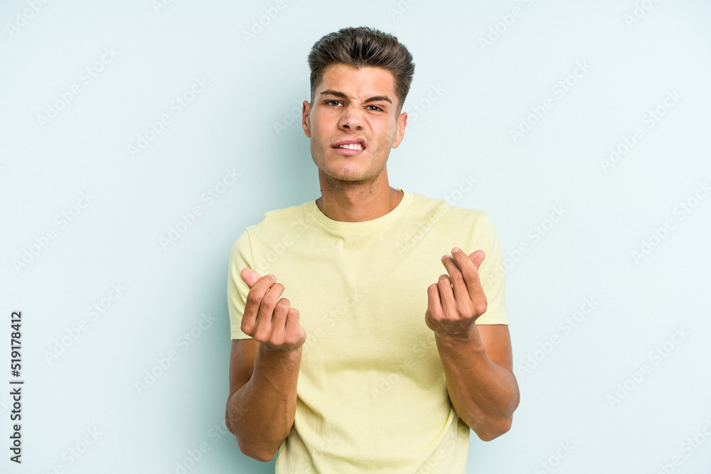 Young caucasian man isolated on blue background showing that she has no money. Young caucasian man isolated on blue background showing that she has no money.
