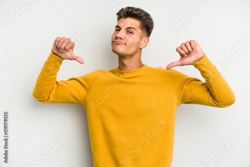 Valokuva Young caucasian man isolated on white background feels proud and self confident, example to follow