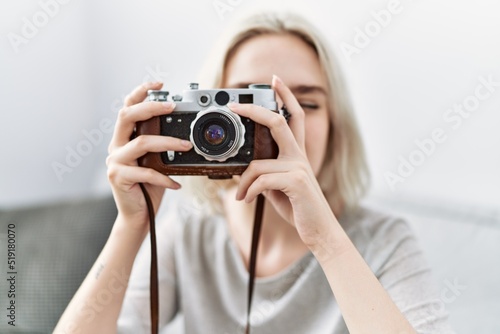 Young caucasian woman smiling confident using camera at home