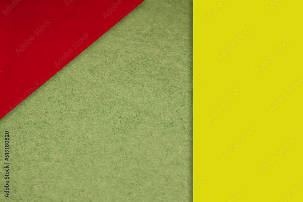 Textured and plain neon red yellow green sheet papers forming two triangles and vertical blank rectangle for creative cover designing Textured and plain neon red yellow green sheet papers forming two triangles and vertical blank rectangle for creative cover designing