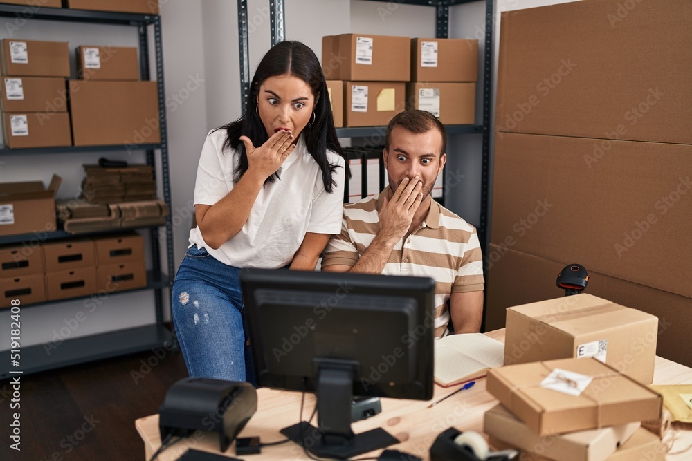 Young hispanic people working at small business ecommerce covering mouth with hand, shocked and afraid for mistake. surprised expression Young hispanic people working at small business ecommerce covering mouth with hand, shocked and afraid for mistake. surprised expression