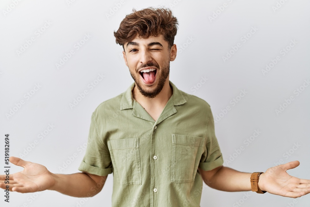 Young arab doctor man standing over isolated background sticking tongue out happy with funny expression. emotion concept. Young arab doctor man standing over isolated background sticking tongue out happy with funny expression. emotion concept.
