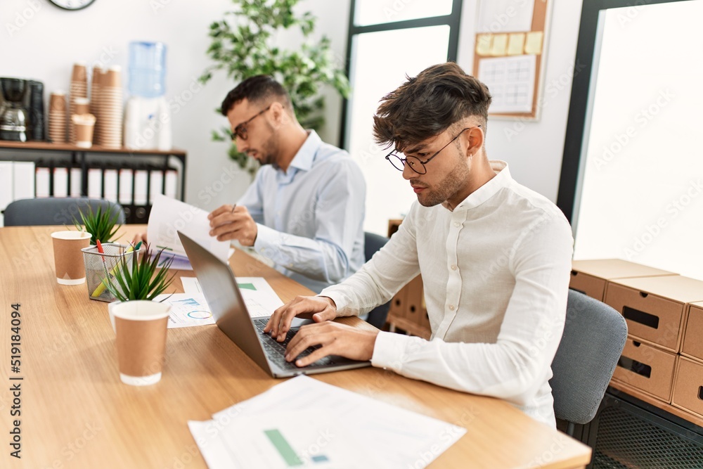 Two hispanic men business workers concentrate working at office Two hispanic men business workers concentrate working at office