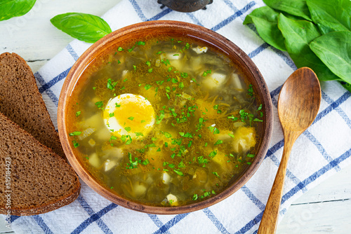 Sorrel soup in bowl. Traditional russian green soup with sorrel photo