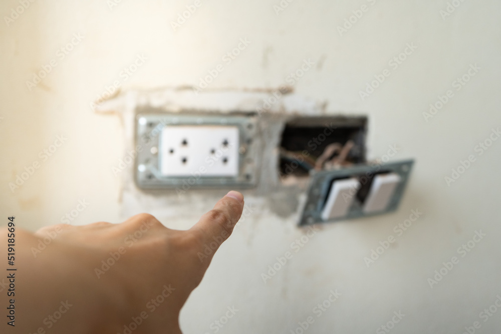 Socket Inspection Close up inspector or audit hand point at plug socket outlet while ...