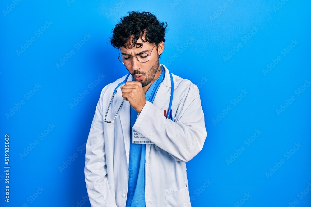 Young hispanic man wearing doctor uniform and stethoscope relax and smiling with eyes closed doing meditation gesture with fingers. yoga concept. Young hispanic man wearing doctor uniform and stethoscope relax and smiling with eyes closed doing meditation gesture with fingers. yoga concept.