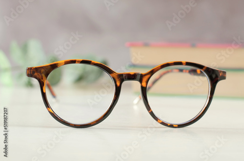 Stylish eyeglasses in leopard color on the desk