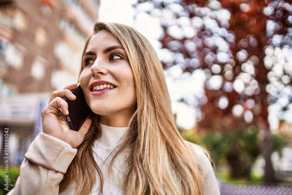 Young blonde woman smiling confident talking on the smartphone at street Young blonde woman smiling confident talking on the smartphone at street