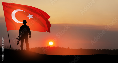 Silhouette of soldier with Turkey flag on background of sunset. Concept of crisis of war and political conflicts between nations. Greeting card for Turkish Armed Forces Day, Victory Day.