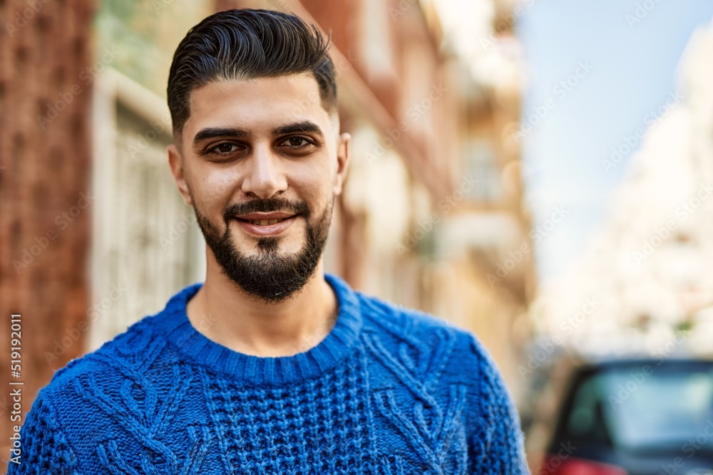 Fototapeta premium Young arab man smiling confident at street