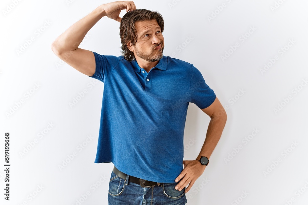 Handsome middle age man standing together over isolated background confuse and wondering about question. uncertain with doubt, thinking with hand on head. pensive concept. Handsome middle age man standing together over isolated background confuse and wondering about question. uncertain with doubt, thinking with hand on head. pensive concept.