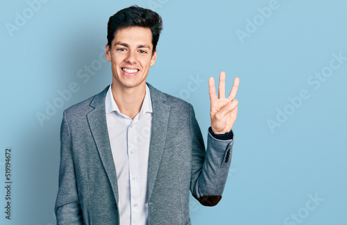 Canvas Print Young hispanic man wearing business clothes showing and pointing up with fingers number three while smiling confident and happy