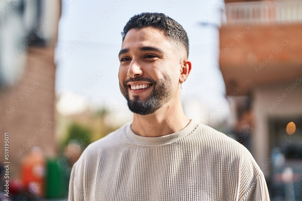 Young arab man smiling confident standing at street Young arab man smiling confident standing at street