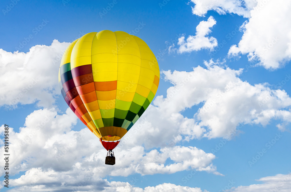Fototapeta premium Colorful hot air balloon flying over blue sky