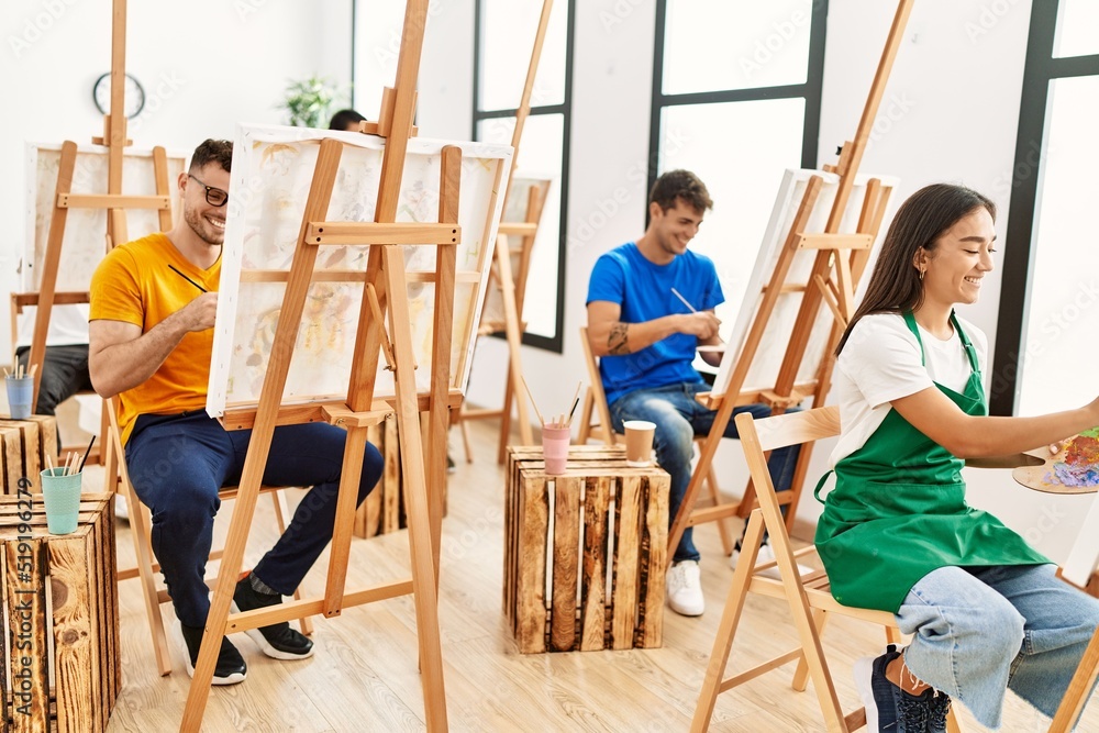 Group of people smiling happy drawing at art studio.