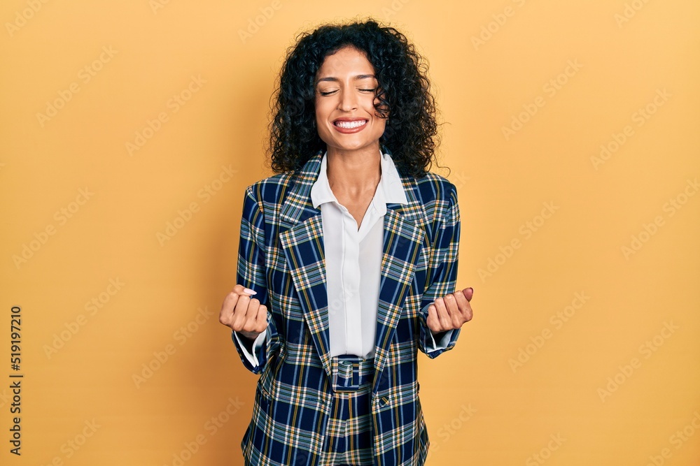 Φωτογραφία Young latin girl wearing business clothes very happy and excited doing winner gesture with arms raised, smiling and screaming for success