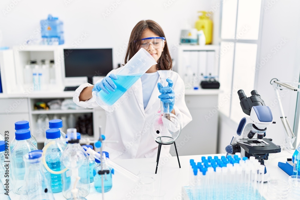 Young hispanic girl working at laboratory Young hispanic girl working at laboratory