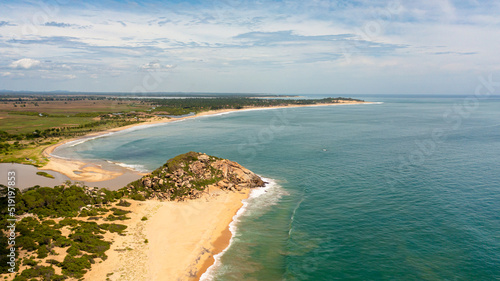 Tropical landscape with a beautiful beach in the blue water. Crocodile Rock  Sri Lanka.