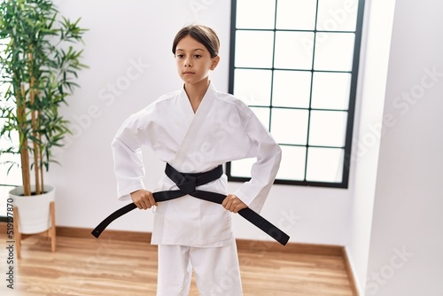 Young hispanic girl doing martial arts at training studio