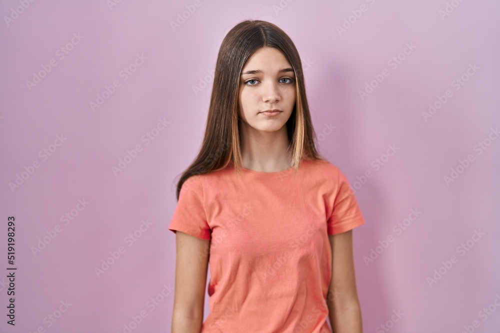 Teenager girl standing over pink background looking sleepy and tired, exhausted for fatigue and hangover, lazy eyes in the morning. Teenager girl standing over pink background looking sleepy and tired, exhausted for fatigue and hangover, lazy eyes in the morning.