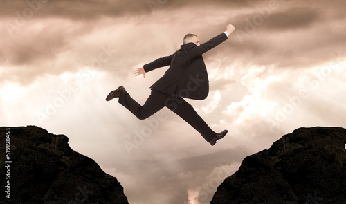 Businessman jumping from one mountain to another one © Minerva Studio