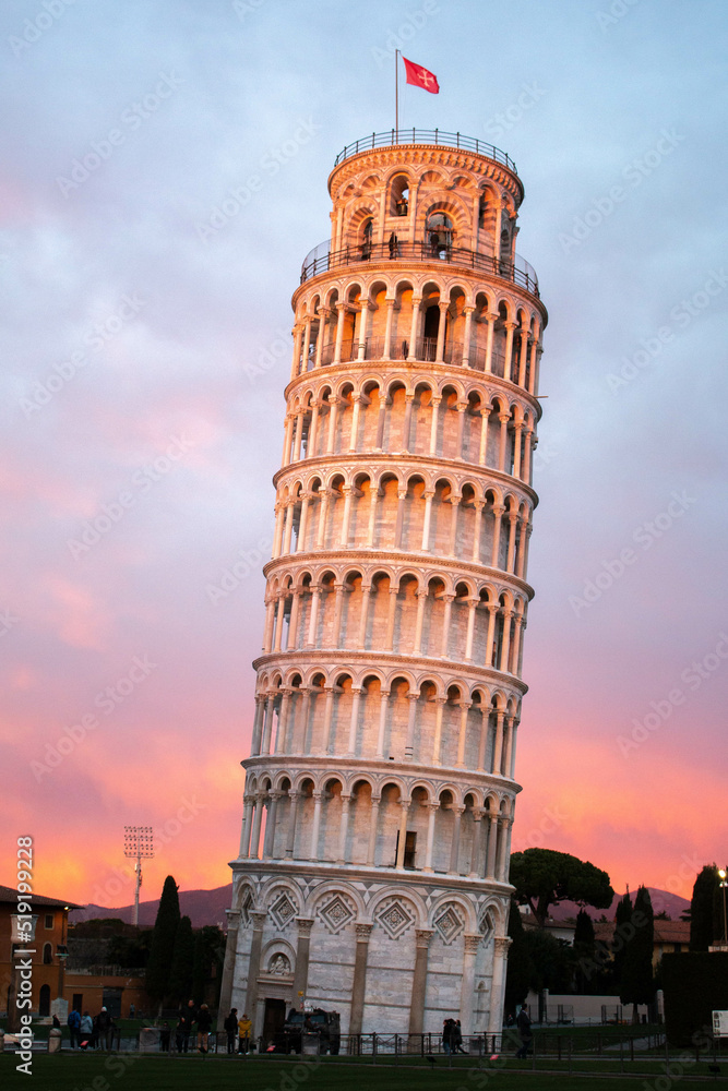 Incredible view of the Leaning Tower of Pisa, during sunset, in the city of Pisa.