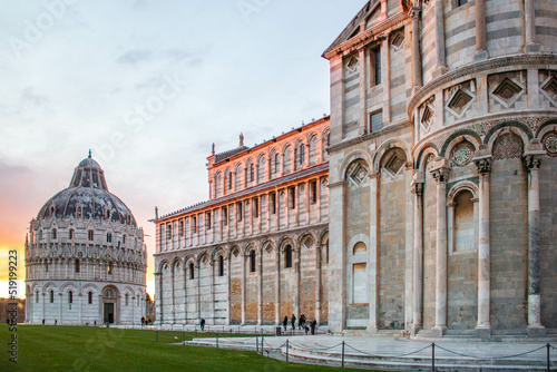 Baptistery of Pisa and Cathedral of Pisa , in the foreground, during an incredible pink sunset. Italy. 