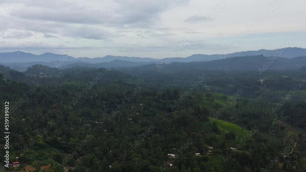 Aerial drone of Mountain slopes with rainforest and a mountain valley with farmland. Sri Lanka. Aerial drone of Mountain slopes with rainforest and a mountain valley with farmland. Sri Lanka.