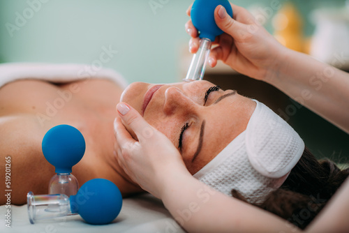 Tableau sur toile Face cupping therapy, ventosa cupping treatment for strong face lifting
